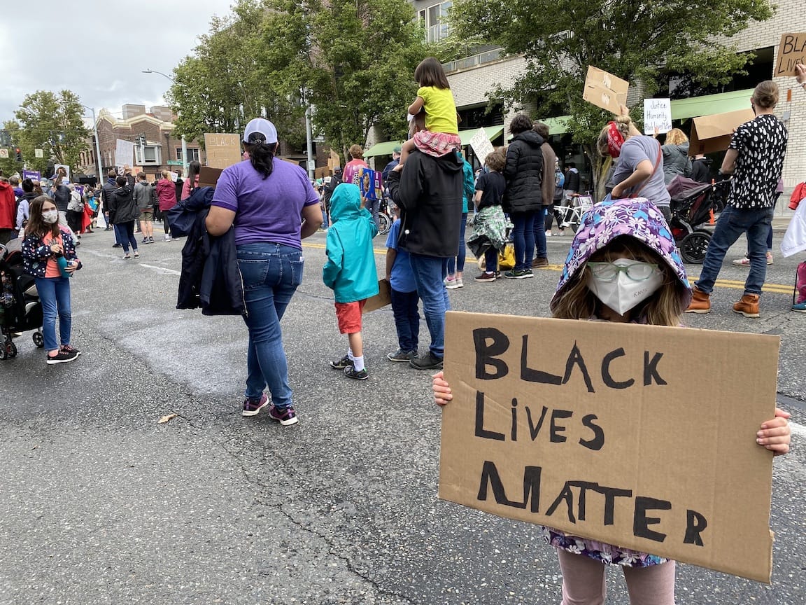 Gwen, holding a Black Lives Matter sign she made